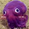 A purple stubby squid edited to have cartoony blush on it.